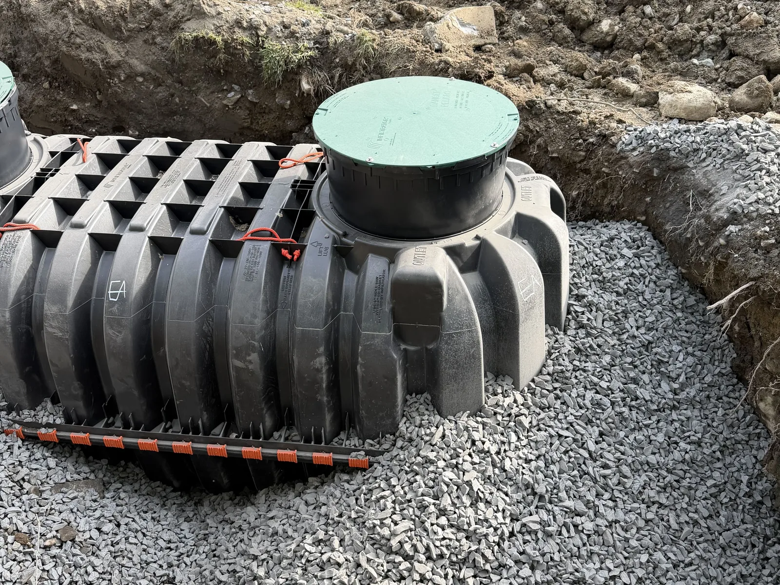 Aerobic septic tank bedded on crushed stone in the open excavation